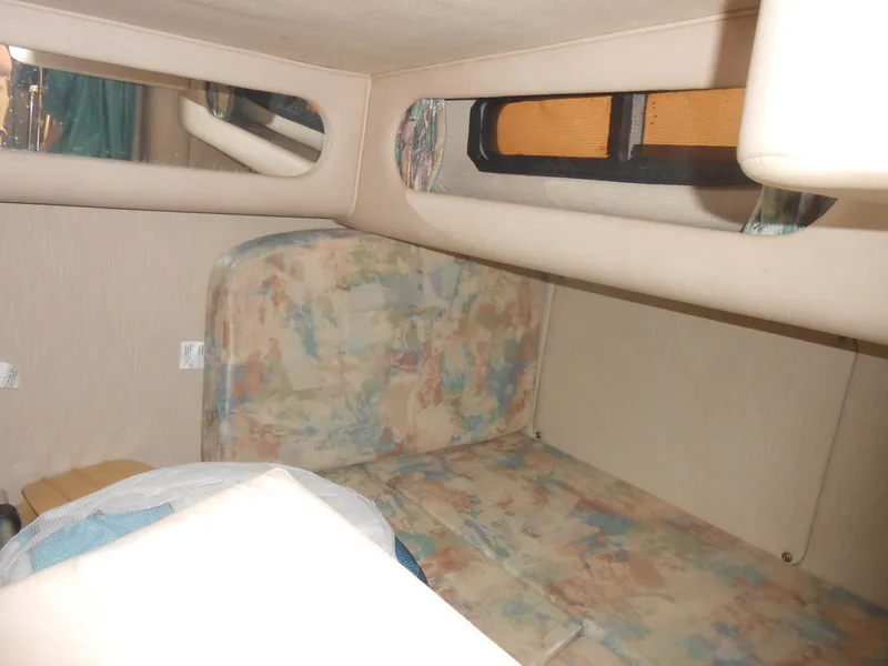 Slide: The Image of 1996 Sea Ray 290 Sundancer cabin interior with patterned upholstery and window. - 26