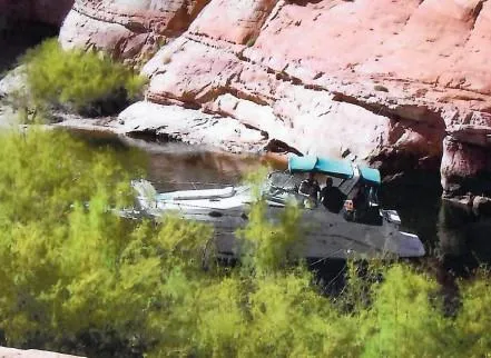 Slide: The Image of 1996 Sea Ray 290 Sundancer boat in a rocky, secluded waterway with lush greenery. - 3