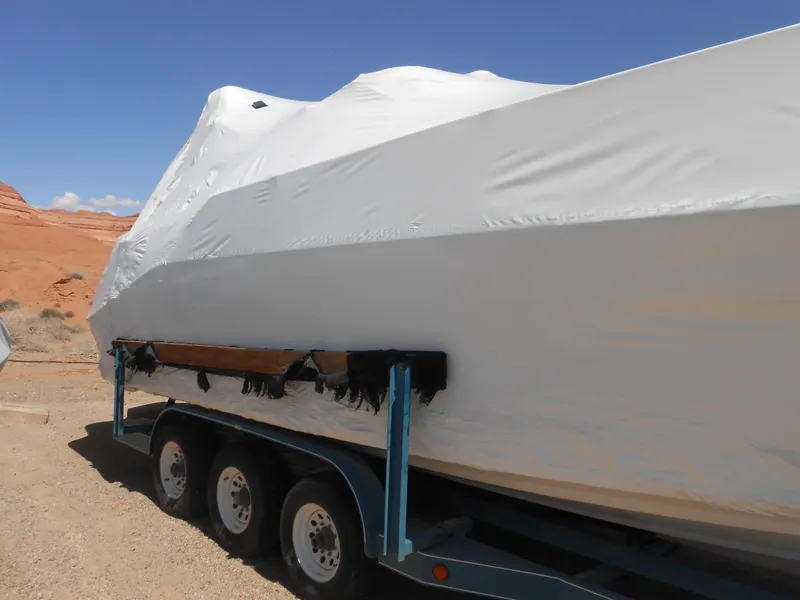 Slide: The Image of Covered 1996 Sea Ray 290 Sundancer boat on trailer in desert landscape. - 7