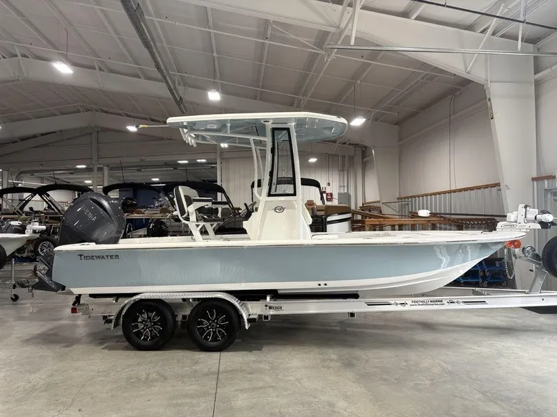 The Image of 2026 Tidewater 2110 BM boat on trailer in indoor showroom. - 1