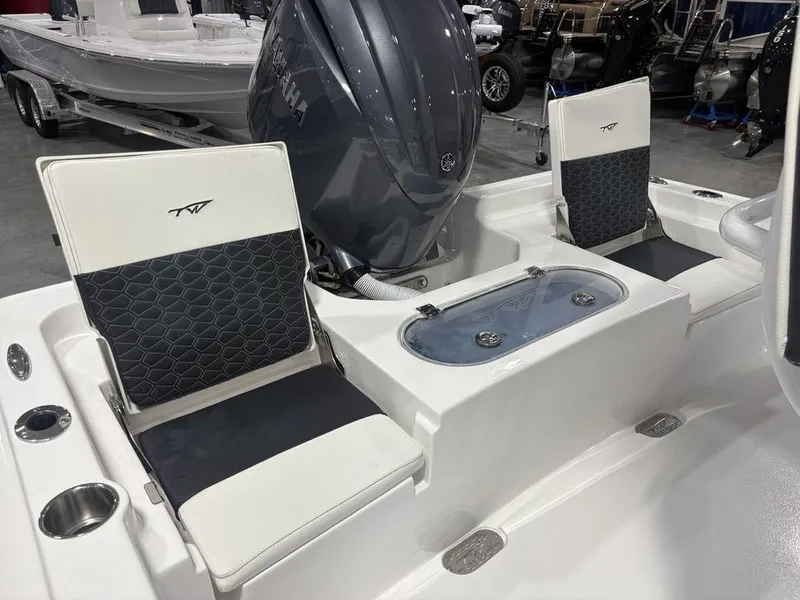Slide: The Image of 2026 Tidewater 2110 BM boat interior with seating and Yamaha engine. - 18