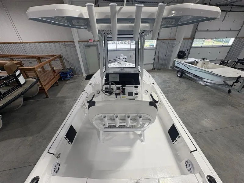 Slide: The Image of 2026 Tidewater 2110 BM boat interior with steering console and seating in a showroom. - 21