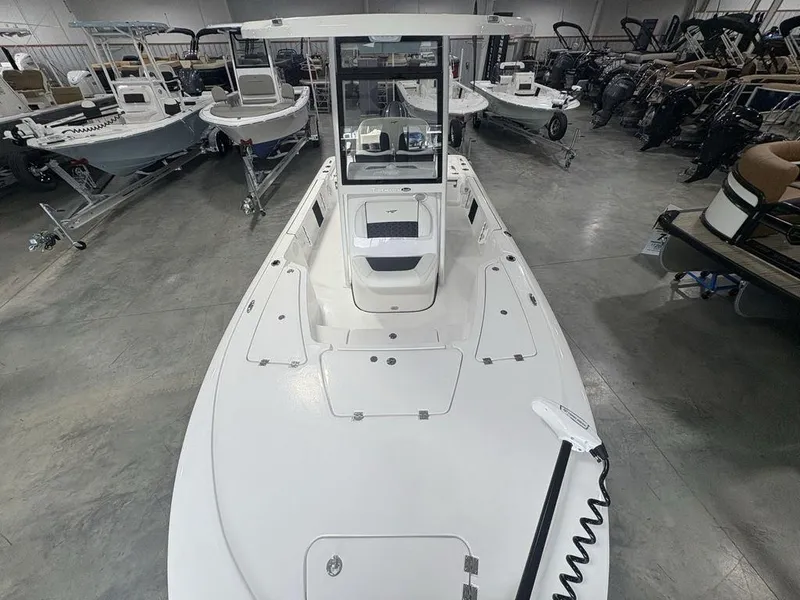 Slide: The Image of 2026 Tidewater 2110 BM boat in showroom, surrounded by other boats. - 23