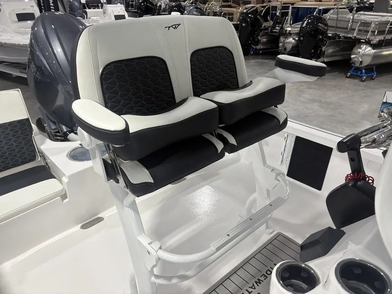 Slide: The Image of 2026 Tidewater 2110 BM boat seating with dual cushioned seats and armrests in a showroom. - 25