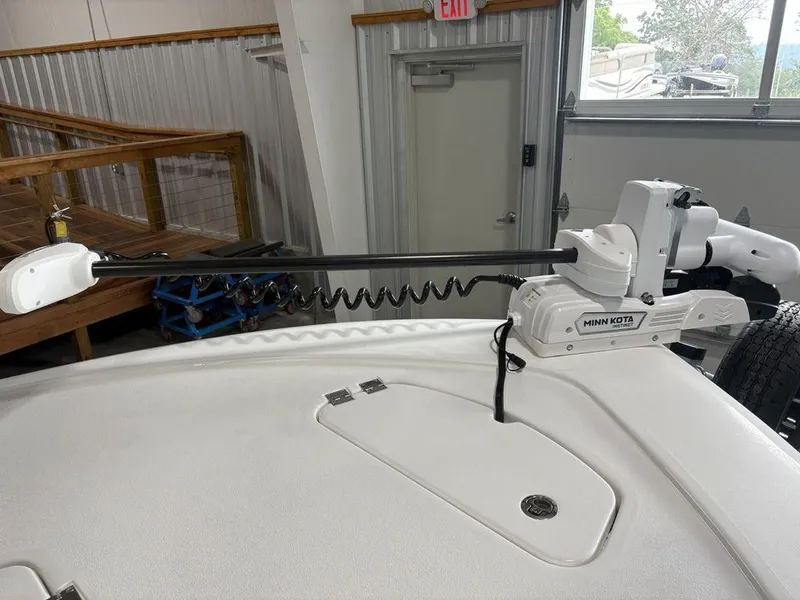 Slide: The Image of 2026 Tidewater 2110 BM boat with Minn Kota trolling motor in a garage setting. - 5