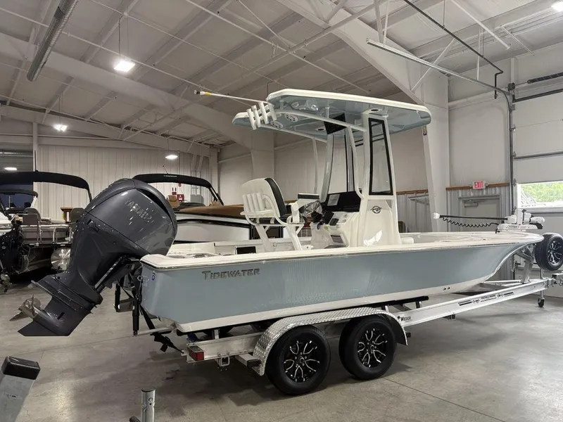 Slide: The Image of 2026 Tidewater 2110 BM boat in showroom, mounted on a trailer, with outboard motor. - 8