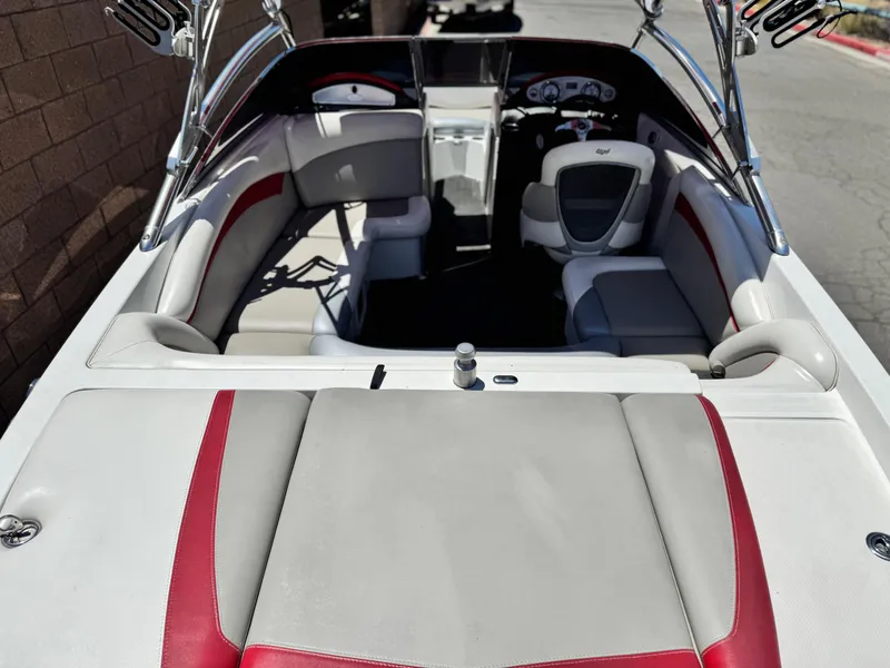 Slide: The Image of 2008 Tigé RZ2 boat interior with red and white seating, sleek design. - 10