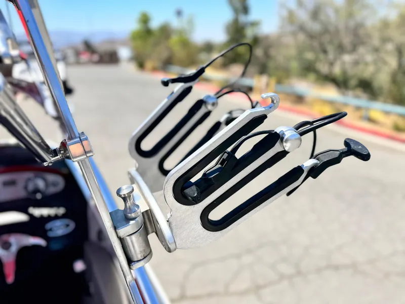 Slide: The Image of Wakeboard rack on a 2008 Tigé RZ2 boat, sunny outdoor setting. - 13