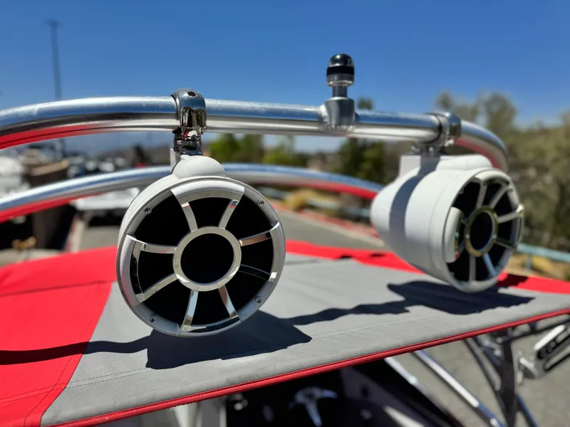 Slide: The Image of Speakers mounted on a 2008 Tigé RZ2 boat with a red and gray canopy. - 14