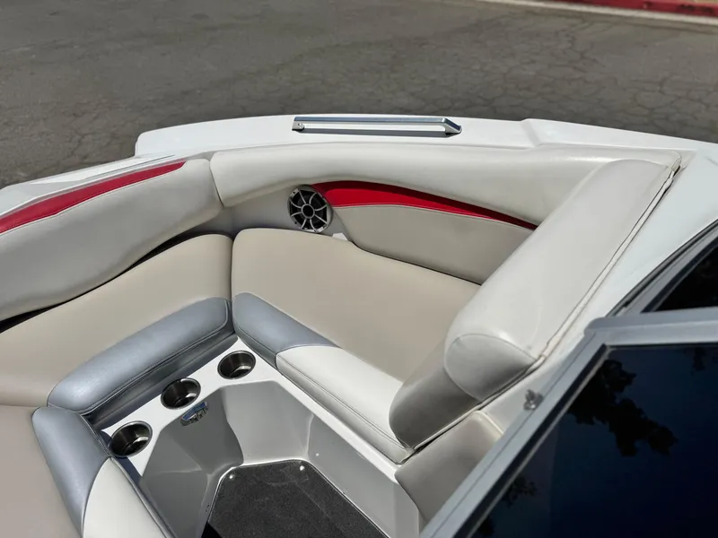 Slide: The Image of 2008 Tigé RZ2 boat interior with red and white seating, cup holders, and speaker. - 18