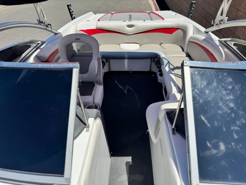 Slide: The Image of 2008 Tigé RZ2 boat interior with red and white seating, open cockpit view. - 19