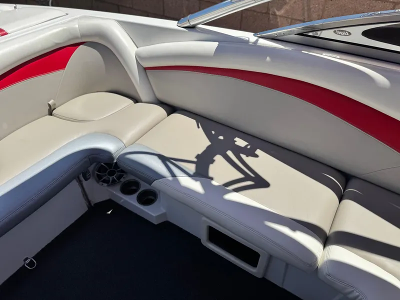 Slide: The Image of 2008 Tigé RZ2 boat interior with red and gray seating, cup holders, and speaker. - 22