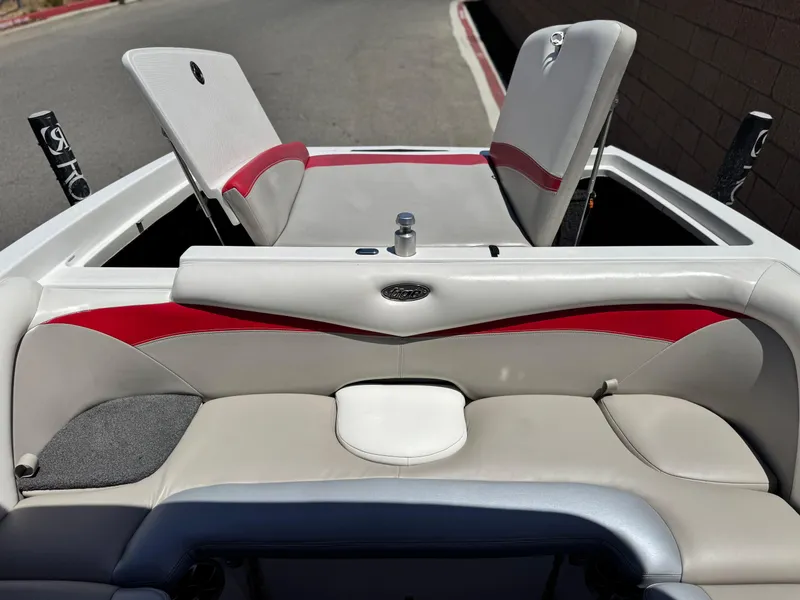 Slide: The Image of 2008 Tigé RZ2 boat interior with red and gray seating, showcasing sleek design. - 23
