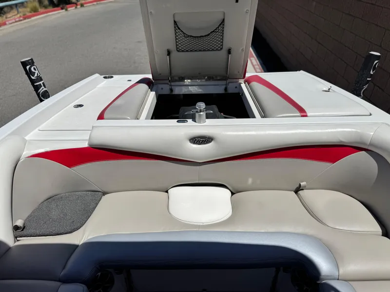 Slide: The Image of 2008 Tigé RZ2 boat interior with red and white seating, open storage compartment. - 25