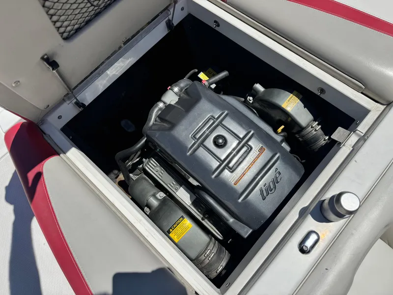 Slide: The Image of 2008 Tigé RZ2 boat engine compartment with visible components and branding. - 26