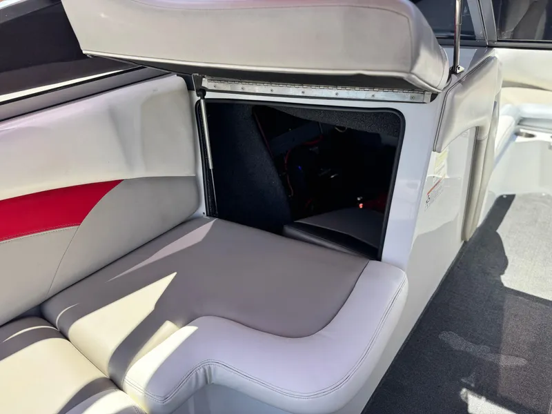 Slide: The Image of 2008 Tigé RZ2 boat interior with open storage compartment and cushioned seating. - 28
