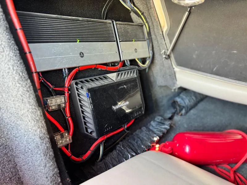 Slide: The Image of Audio system installation in a 2008 Tigé RZ2 boat, featuring amplifiers and wiring. - 29