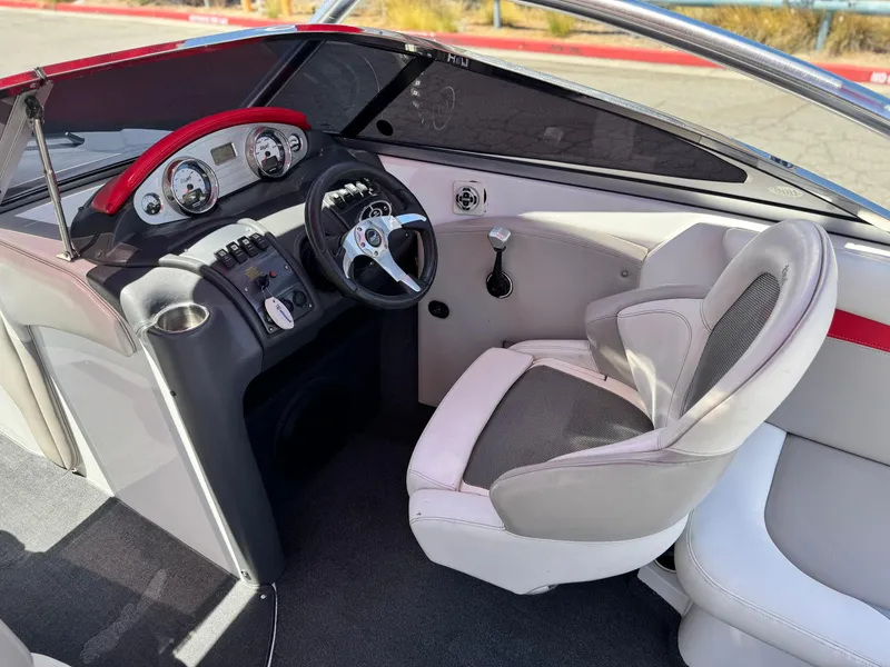 Slide: The Image of 2008 Tigé RZ2 boat interior with steering wheel, dashboard, and captain's chair. - 31