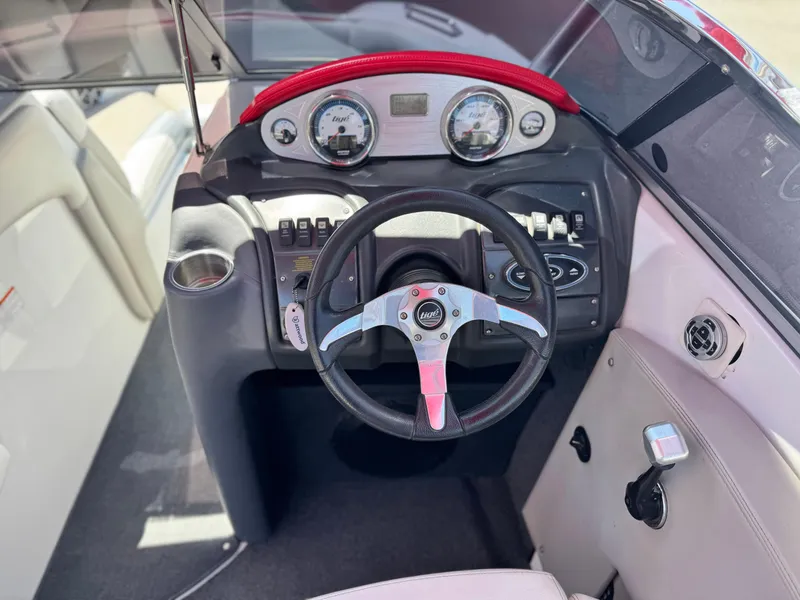 Slide: The Image of 2008 Tigé RZ2 boat dashboard with steering wheel and control panel. - 32