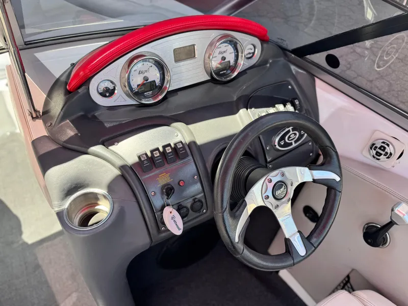 Slide: The Image of 2008 Tigé RZ2 boat dashboard with steering wheel and control panel. - 33