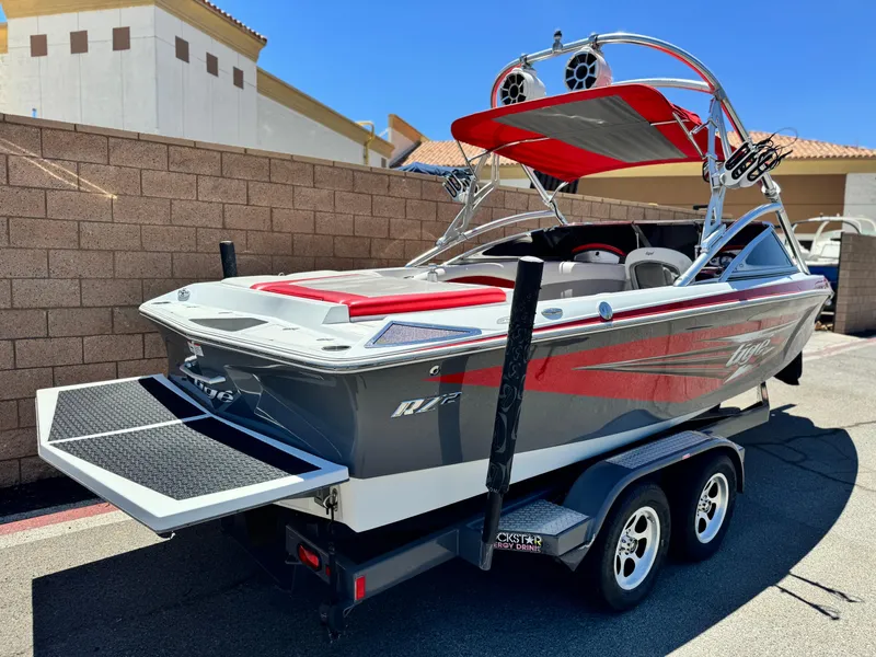 Slide: The Image of 2008 Tigé RZ2 boat on trailer, featuring red and gray design with wakeboard tower. - 5