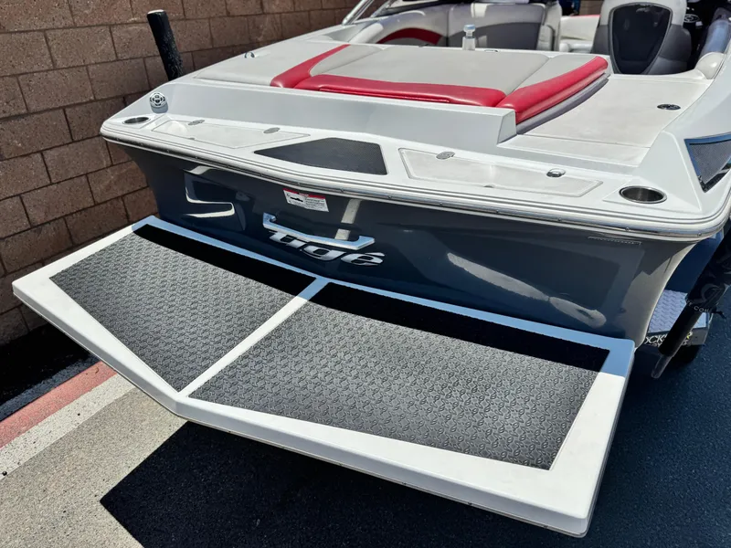 Slide: The Image of 2008 Tigé RZ2 boat rear view with swim platform and red seating. - 6