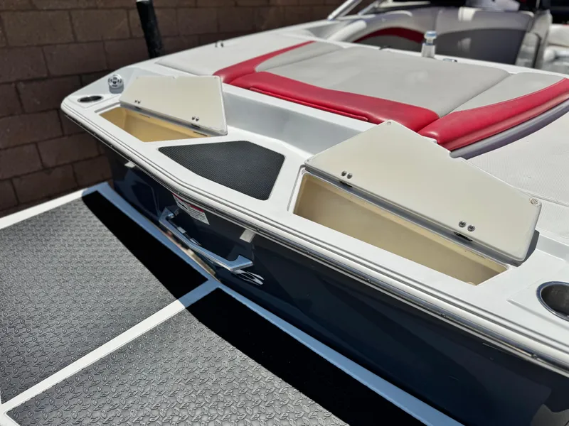 Slide: The Image of 2008 Tigé RZ2 boat with open storage compartments and red seating. - 7