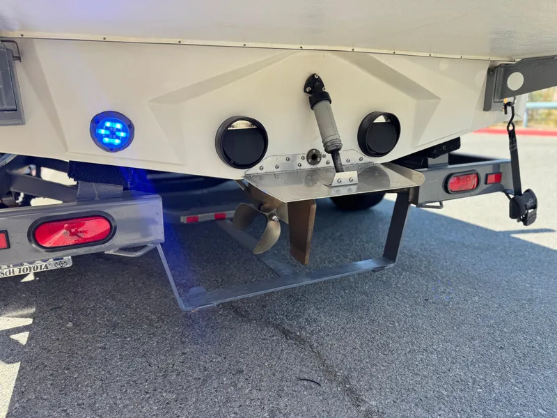 Slide: The Image of 2008 Tigé RZ2 boat stern with propeller and blue LED light on trailer. - 8