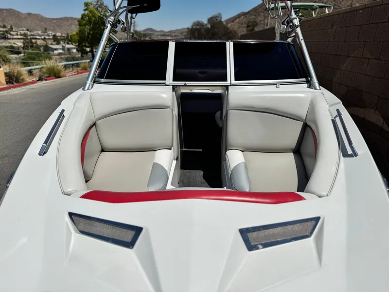Slide: The Image of 2008 Tigé RZ2 boat interior with white and gray seating, red accents, and windshield. - 9