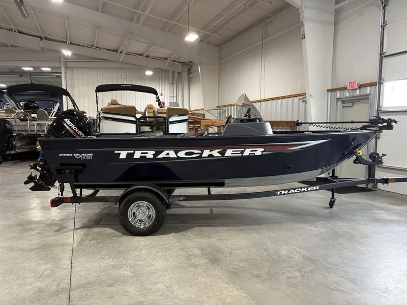 The Image of 2026 Tracker Pro Guide V-16 SC boat in showroom, side view. - 1