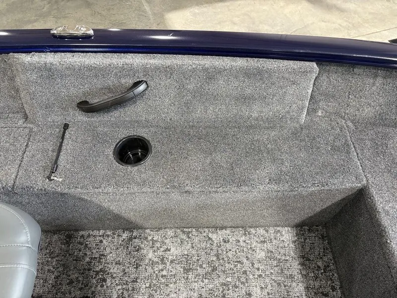 Slide: The Image of 2026 Tracker Pro Guide™ V-16 SC boat interior with gray carpet and cup holder. - 12