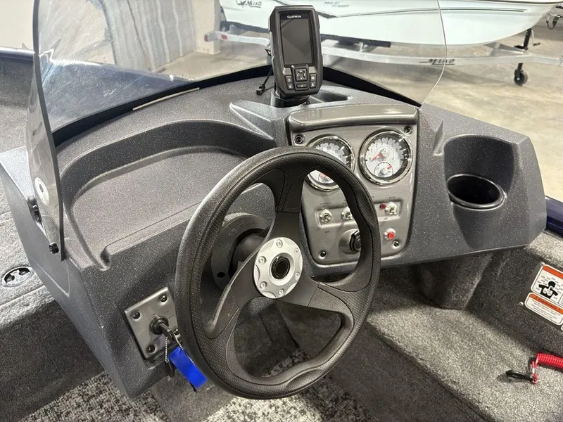 Slide: The Image of 2026 Tracker Pro Guide™ V-16 SC boat dashboard with steering wheel and gauges. - 13