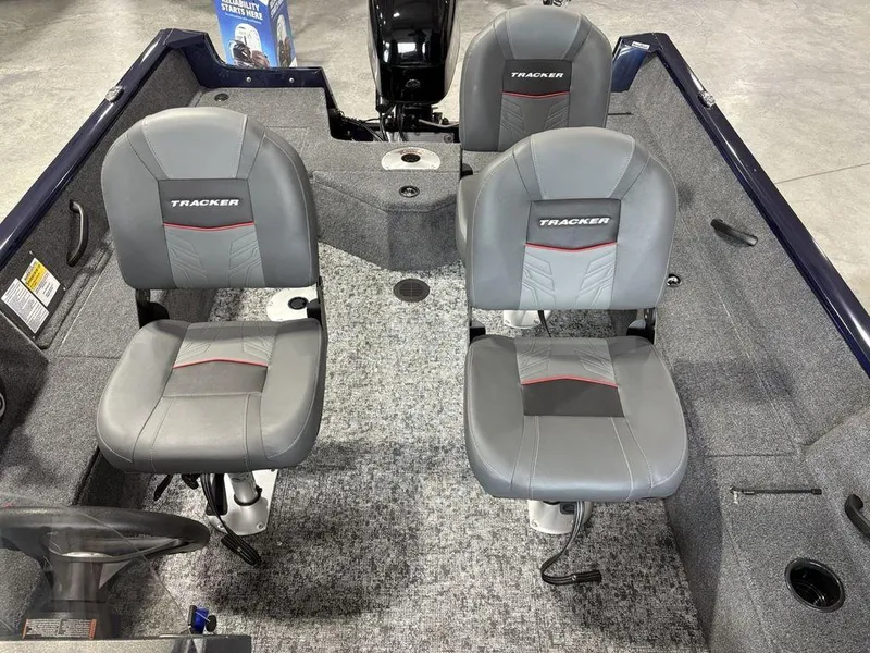 Slide: The Image of 2026 Tracker Pro Guide™ V-16 SC boat interior with gray seating and carpeted flooring. - 14