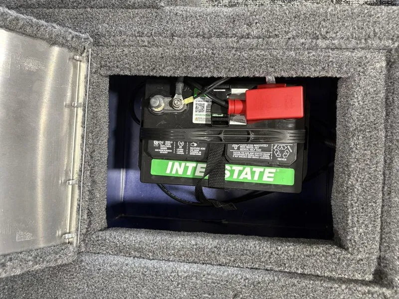 Slide: The Image of Battery compartment of 2026 Tracker Pro Guide™ V-16 SC boat, featuring Interstate battery. - 16