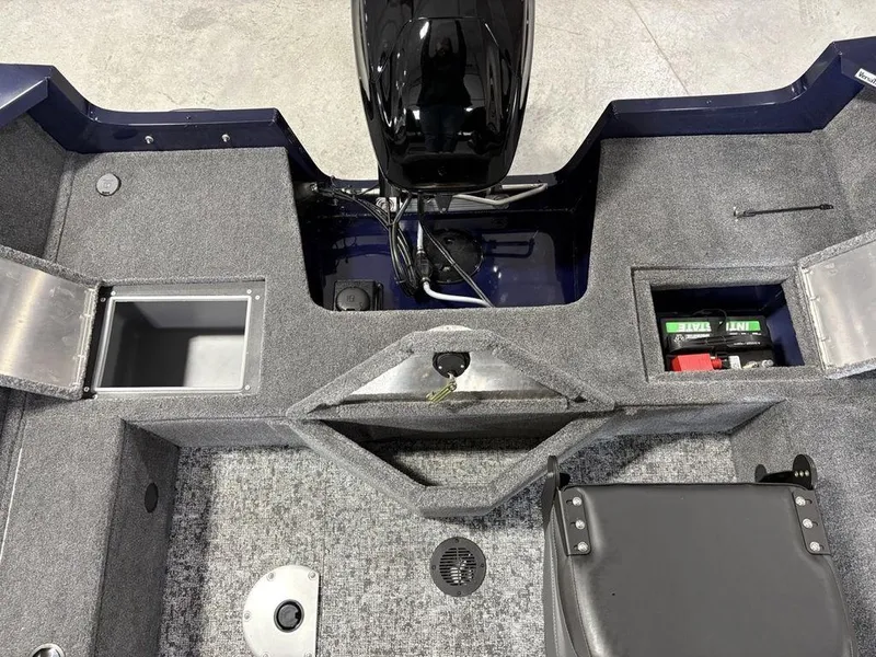 Slide: The Image of 2026 Tracker Pro Guide™ V-16 SC boat interior with storage compartments and motor. - 19