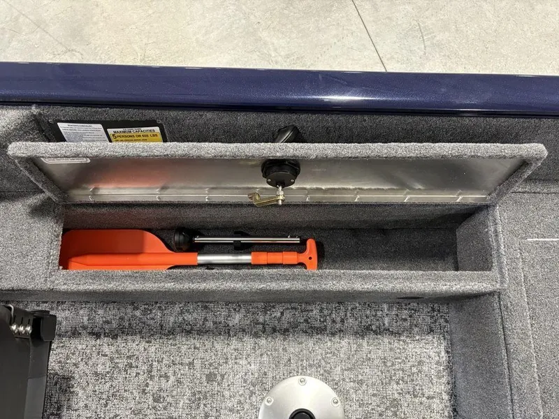 Slide: The Image of Storage compartment of 2026 Tracker Pro Guide™ V-16 SC boat with safety equipment. - 20