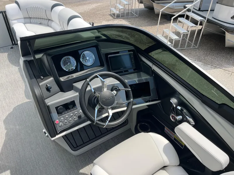 Slide: The Image of 2026 Avalon 2585 Catalina boat dashboard with steering wheel and controls, featuring luxurious seating. - 10