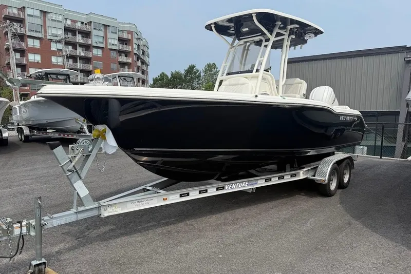 The Image of 2026 Key West 239 FS boat on trailer, parked outdoors near buildings. - 0
