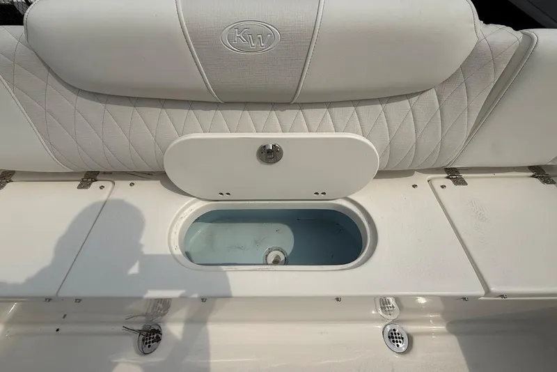 Slide: The Image of 2026 Key West 239 FS boat interior with cushioned seating and storage compartment. - 11