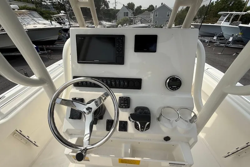 Slide: The Image of 2026 Key West 239 FS boat dashboard with steering wheel and navigation controls. - 14