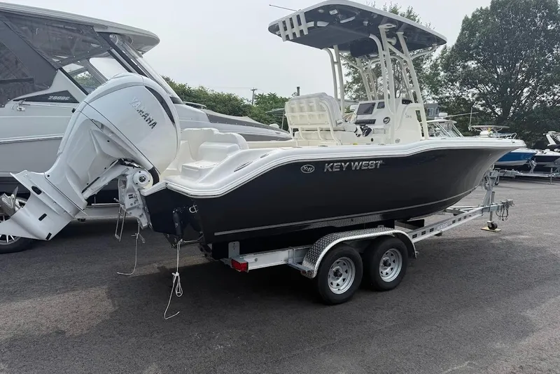 Slide: The Image of 2026 Key West 239 FS boat on trailer with Yamaha outboard motor, parked outdoors. - 3