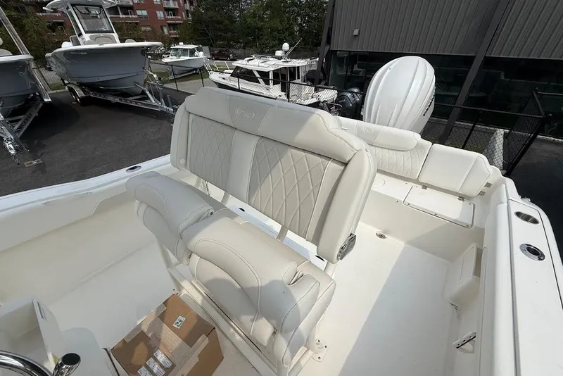 Slide: The Image of 2026 Key West 239 FS boat interior with white seating and modern design. - 8