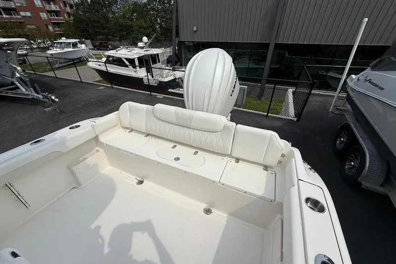 Slide: The Image of 2026 Key West 239 FS boat with white seating and outboard motor in a marina. - 9