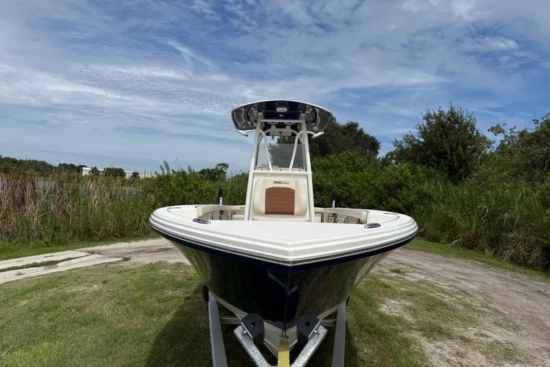 Slide: The Image of 2026 Pathfinder 2700 Open boat on trailer, surrounded by greenery and blue sky. - 10