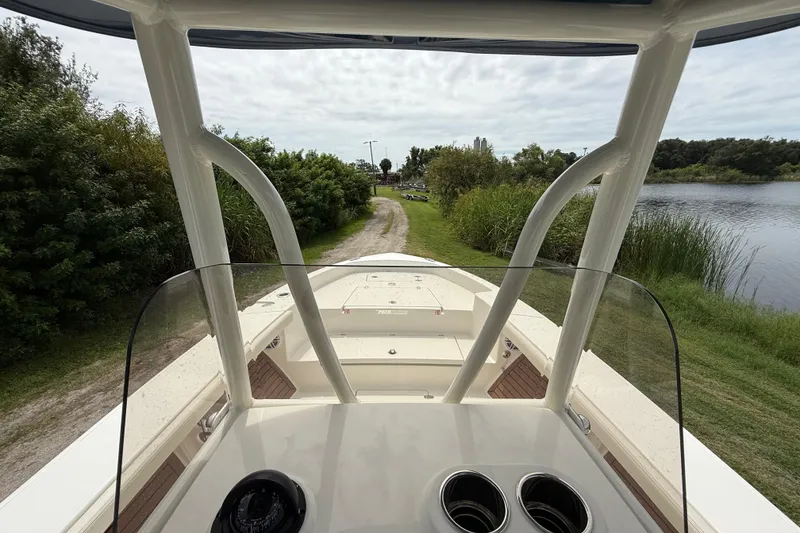 Slide: The Image of 2026 Pathfinder 2700 Open boat on a scenic lakeside path, surrounded by greenery. - 15