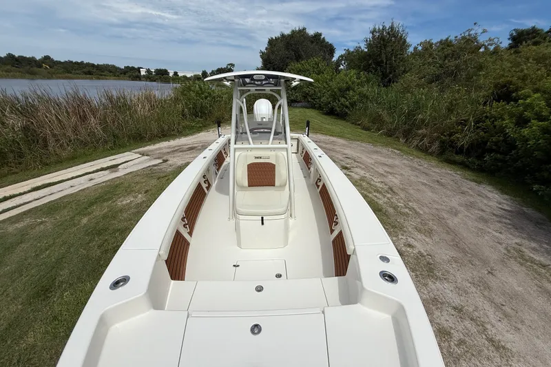 Slide: The Image of 2026 Pathfinder 2700 Open boat on grassy shore near water and trees. - 18