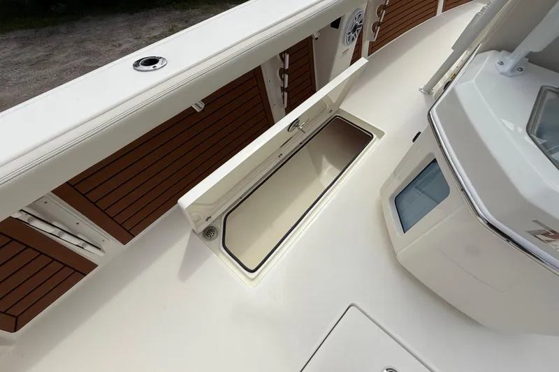 Slide: The Image of 2026 Pathfinder 2700 Open boat deck with storage compartment open. - 28