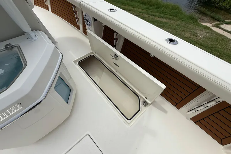 Slide: The Image of 2026 Pathfinder 2700 Open boat deck with storage compartment and sleek design. - 30