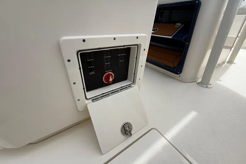 Slide: The Image of Electrical panel on 2026 Pathfinder 2700 Open boat, featuring control switches and a red knob. - 32