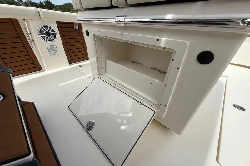 Slide: The Image of 2026 Pathfinder 2700 Open boat storage compartment with open hatch and speaker. - 34